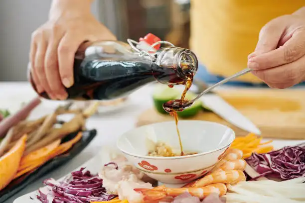 pouring soy sauce into food